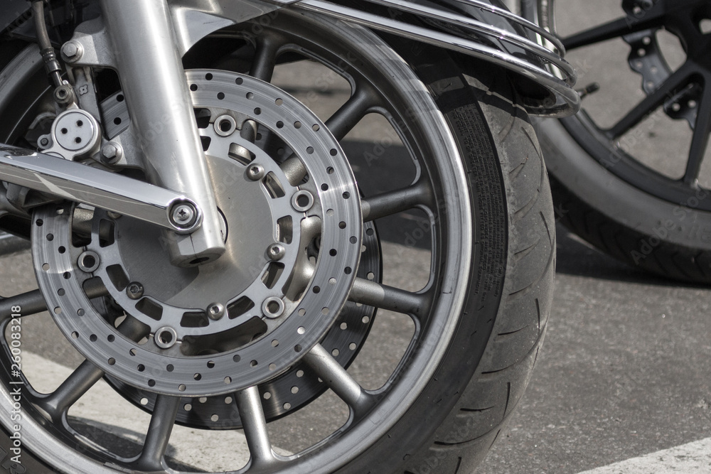 Disk motorcycle wheel. Tire on chopper wheel. Brake pads. Chrome detail of a motorcycle. Motorcycle wheel close up.