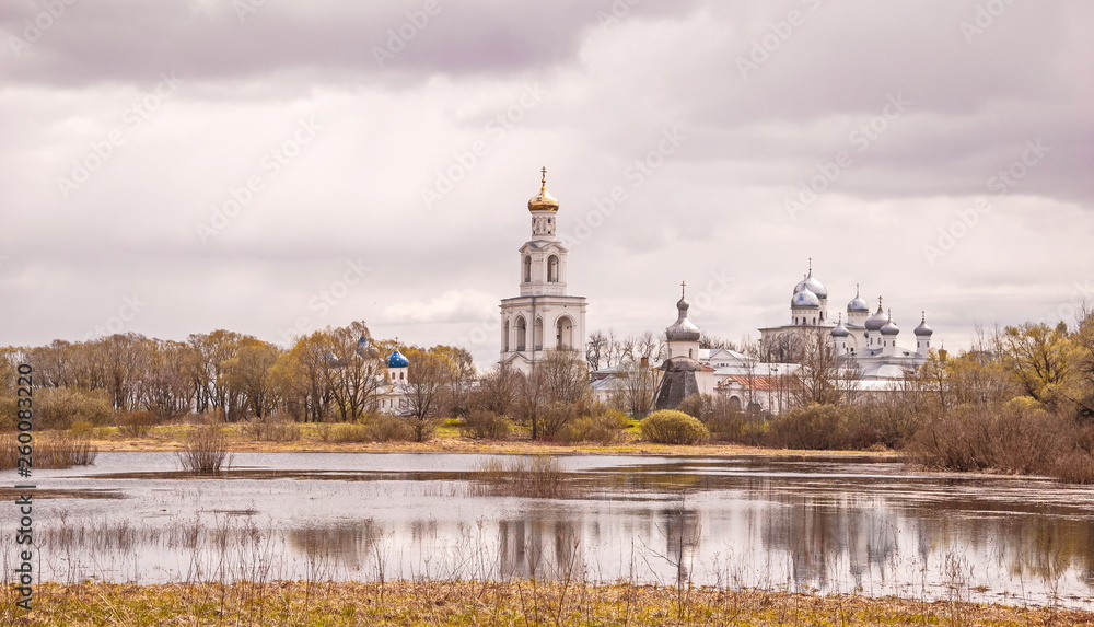 Fototapeta premium The ancient monastery on banks of river in Veliky Novgorod