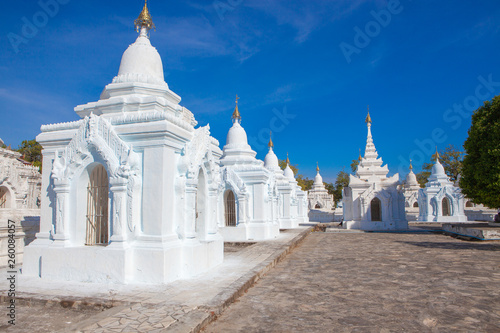 "The world biggest book" contained in white stupas inscribed on large stones at Kuthodaw Pagoda, Mandalay, Myanmar © AnyaNewrcha