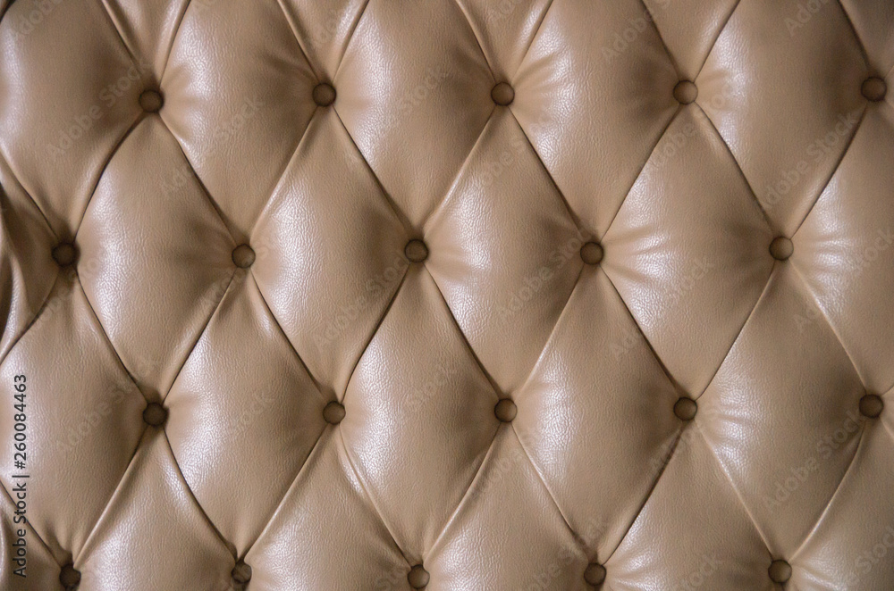Beige leather detailed background with round buttons. Beige leather detailed background with round buttons.