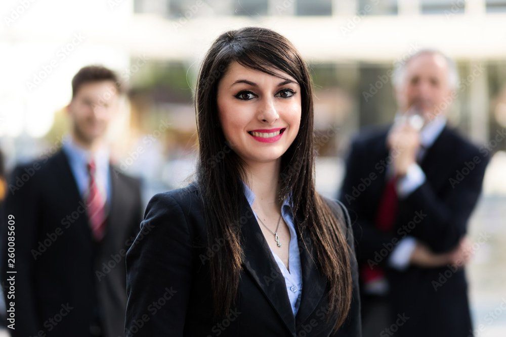 Business team smiling outdoor in a modern urban setting Business team smiling outdoor in a modern urban setting