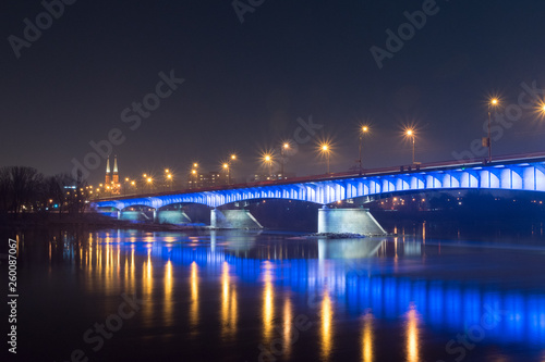 Slasko-Dabrowski bridge over Vistula River at night in Warsaw, Poland.