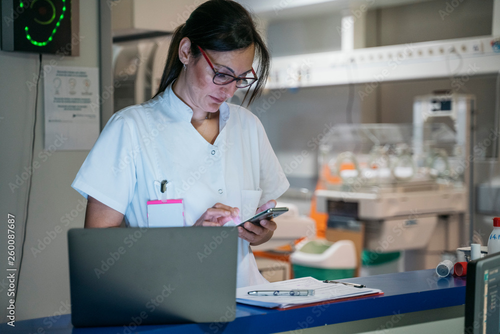 Hospital staff working with smartphone and computer Hospital staff working with smartphone and computer