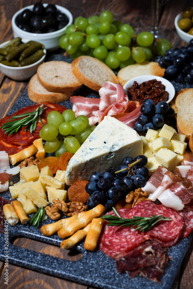 assorted gourmet cheeses and meats, vertical