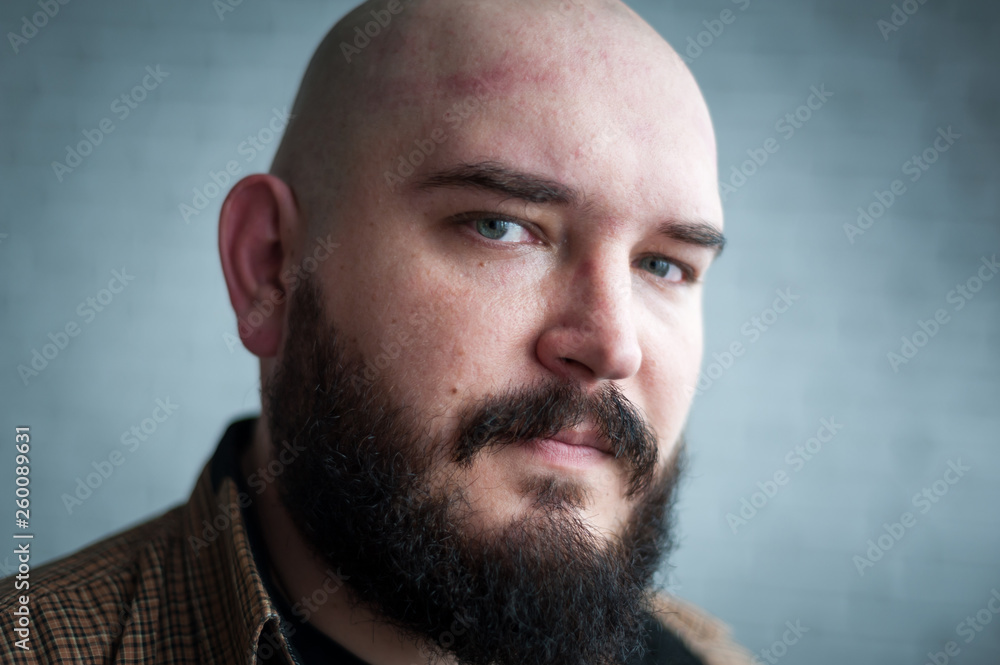 Fototapeta premium Portrait of a bald man in a shirt with a beard