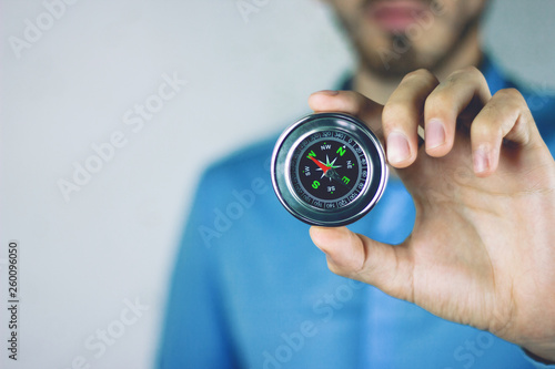 young man hand compass