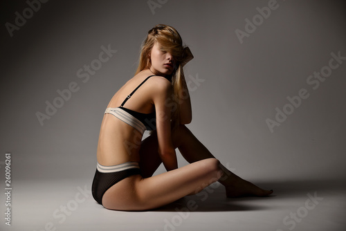 girl blonde in underwear on a gray background © mishadp