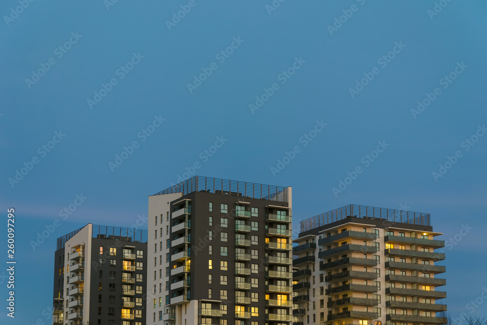 Three residential towers buildings at evening dusk illuminated Three residential towers buildings at evening dusk illuminated