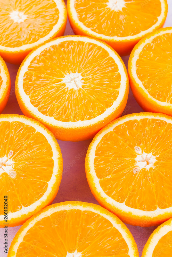 Background of oranges fruits. Many halves of fresh oranges, top view. Citrus for making juice. A lot of sliced oranges on a white background. Concept Background of oranges fruits. Many halves of fresh oranges, top view. Citrus for making juice. A lot of sliced oranges on a white background. Concept