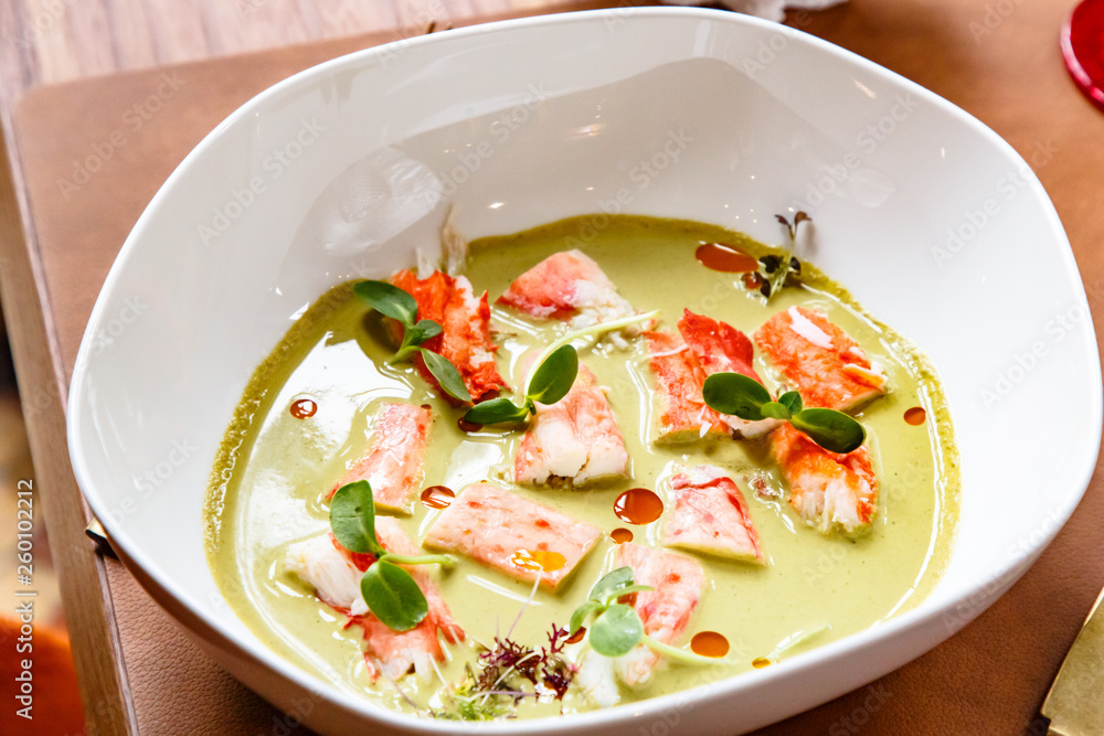 Pieces of crab meat are in green sauce Pieces of crab meat are in green sauce