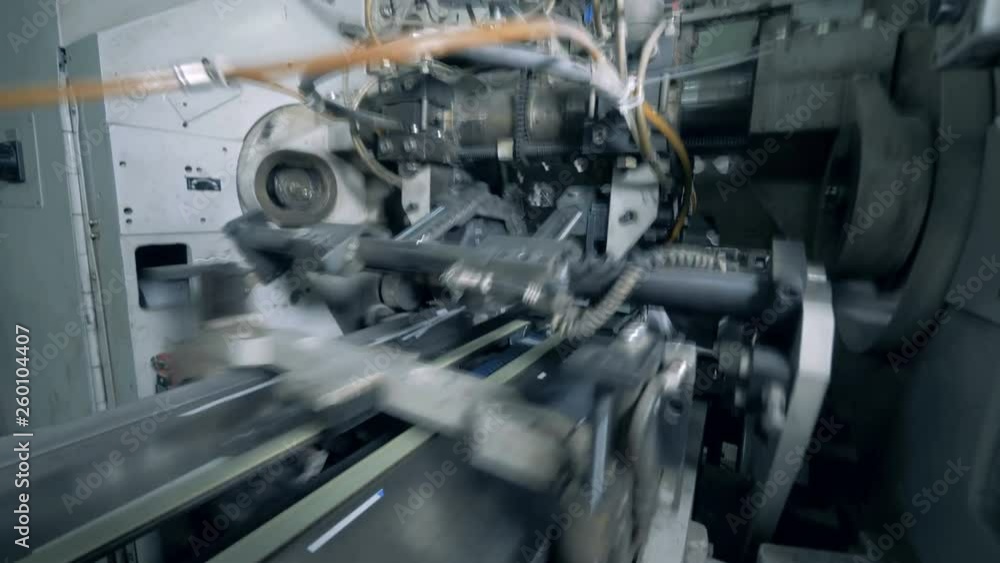 White fiber rolling on bobbins, placed on a factory rack. White fiber rolling on bobbins, placed on a factory rack.