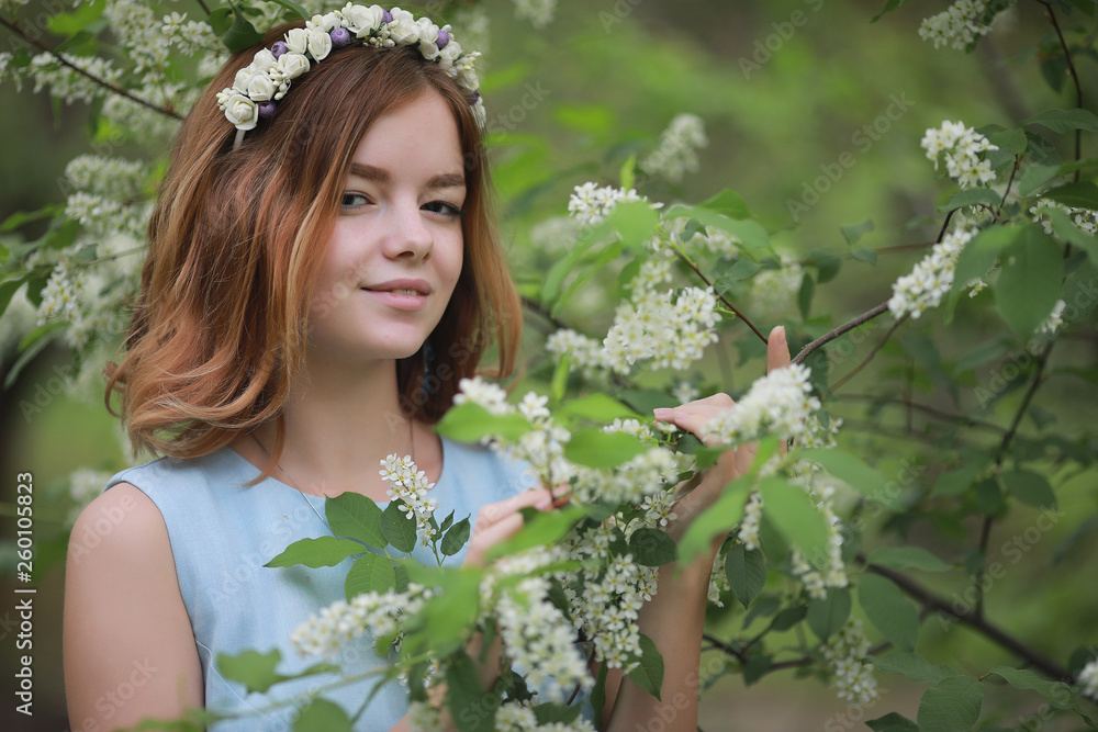 Fototapeta premium Girl in blue dress in green park