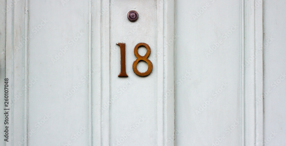 Number 18 on a white house door Number 18 on a white house door