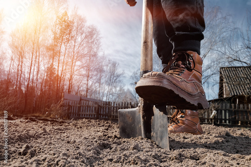 Boots and shovel closeup. The concept of the garden, the beginning of the season, summer cottage.