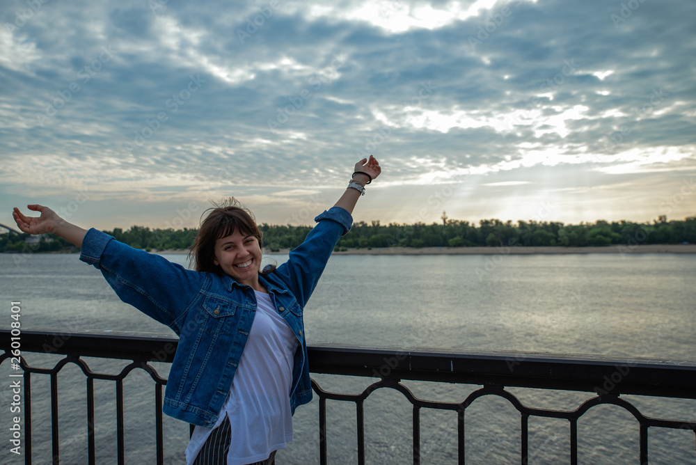 young smiling pretty woman at riverside on sunrise young smiling pretty woman at riverside on sunrise
