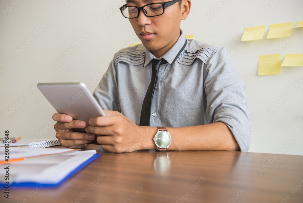 Young businessman using tablet in the office Young businessman using tablet in the office