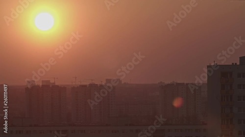 Time lapse shot of the sunset. The sun hides behind the buildings 4k 50fps