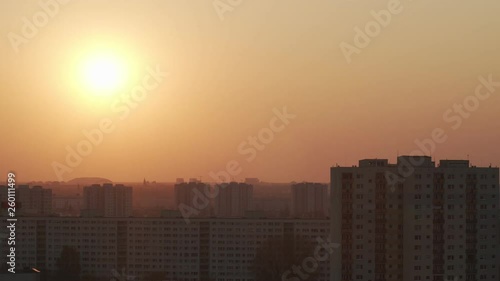 Time lapse shot of the sunset. The sun hides behind the buildings 4k 50fps