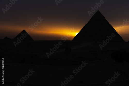 The pyramids at sunset  silhouettes in the dark  Giza  Egypt