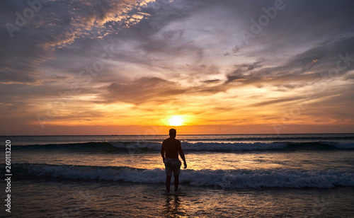 A man walks into the water at sunset © Eduard Vladimirovich