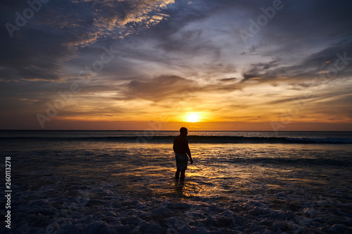 Man watching sunset on the beach