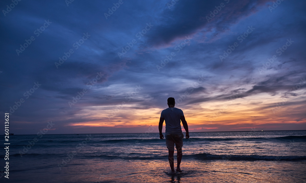 Man watching sunset on the beach