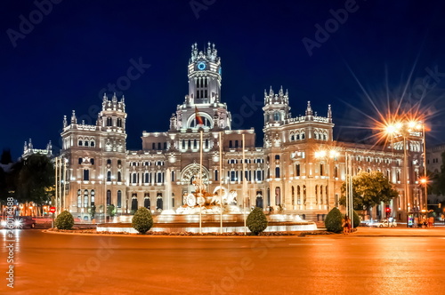 Cybele palace and fountain on Cibeles square at night, Madrid, Spain photo