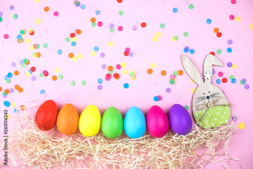 Colored Easter eggs on pink background. Flatlay.