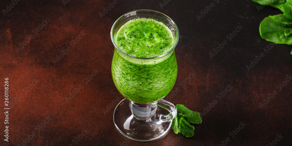 green smoothie. cocktail of vegetables and herbs - the concept of a healthy lifestyle. food background. top image green smoothie. cocktail of vegetables and herbs - the concept of a healthy lifestyle. food background. top image