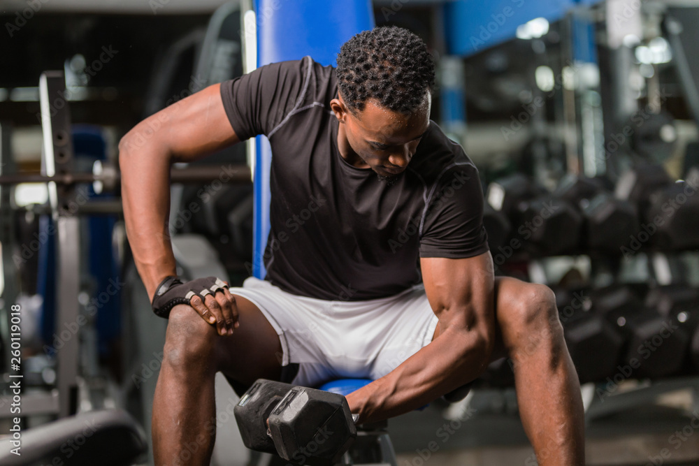 Black African American young man doing workout at the gym Black African American young man doing workout at the gym