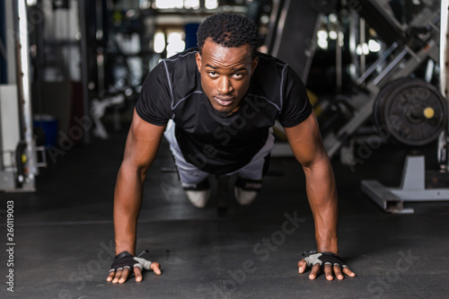 Black African American young man doing workout at the gym