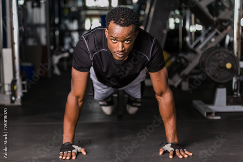 Black African American young man doing workout at the gym
