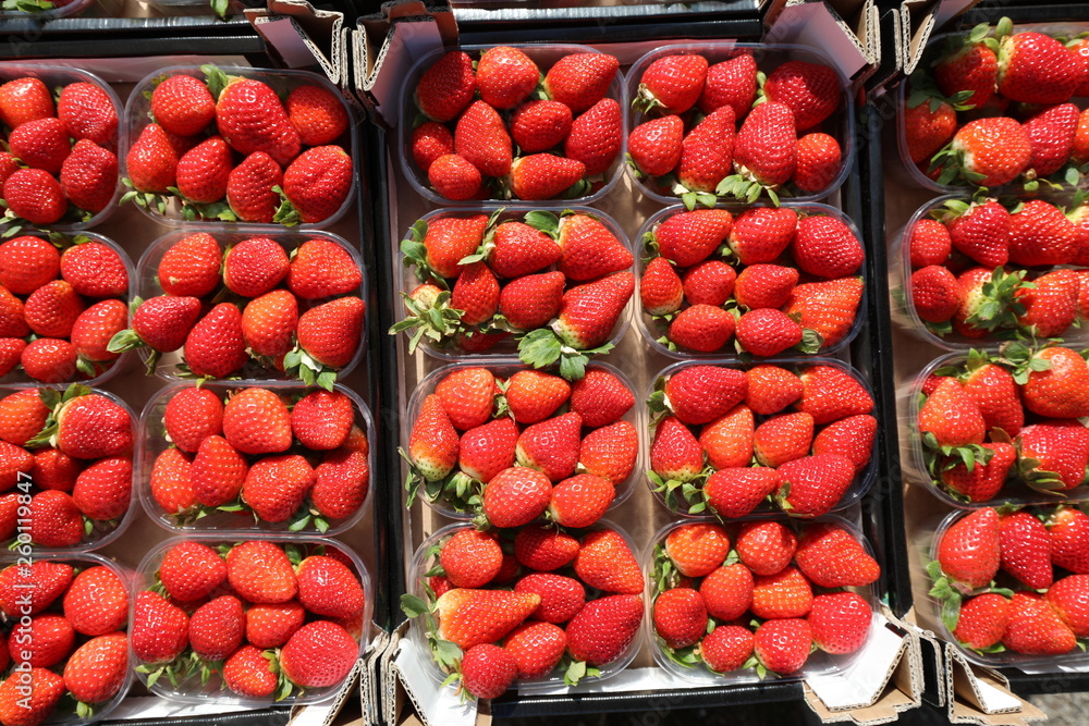 small basket of red ripe strawberries for sale in the greengroce