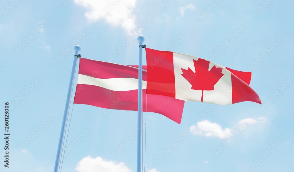 Canada and Latvia, two flags waving against blue sky. 3d image