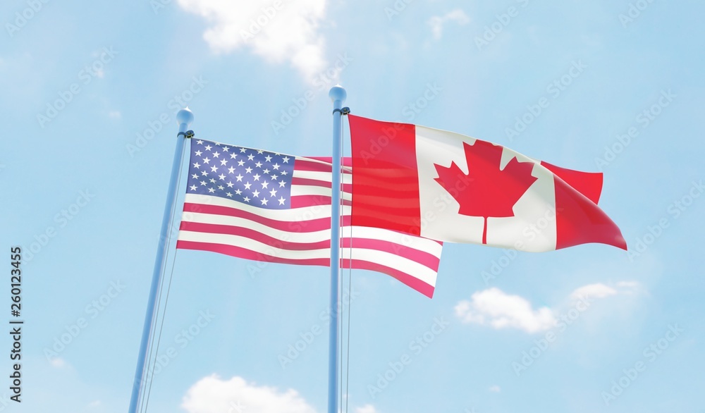 Canada and USA, two flags waving against blue sky. 3d image