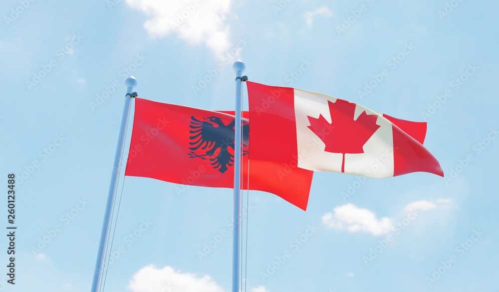 Canada and Albania, two flags waving against blue sky. 3d image
