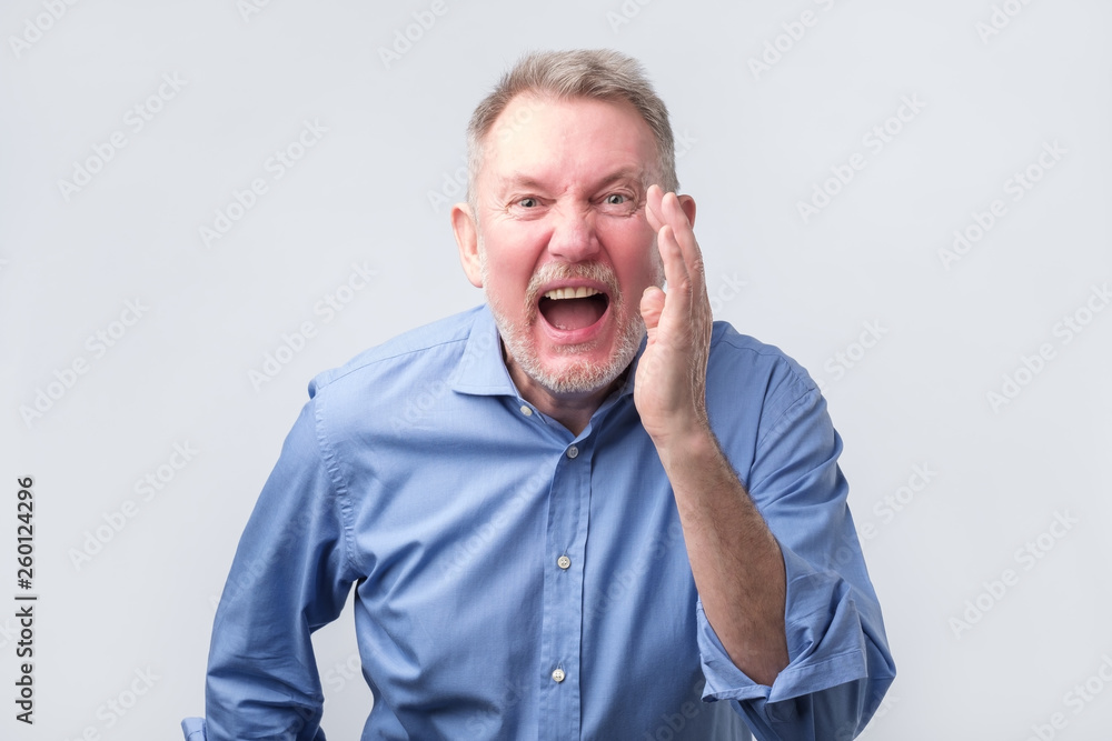 Senior leader man in blue shirt shouting. Senior leader man in blue shirt shouting.