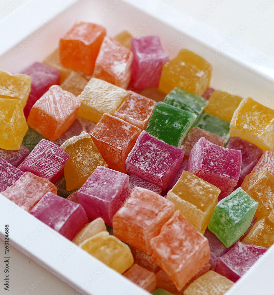 red, green, yellow and orange small Turkish delight, close up of tiny turkish delight in plate