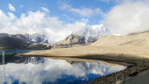 Beautiful landscape of vast sky mountain and lake with reflection of cloud in clean water in nature © Souvik
