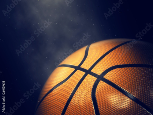 Basketball lit by spotlight close up with copy space