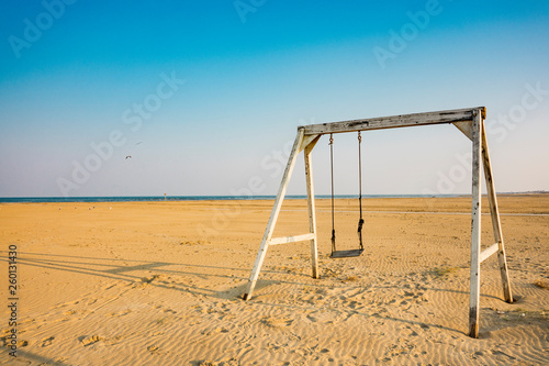 swing on beach of Lido di Spina, Italy