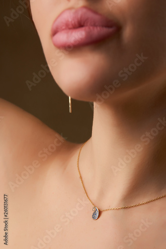 Elegant lady with precious necklace, close-up portait. 