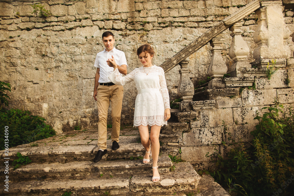 Charming and fashionable couple in love background old vintage castle