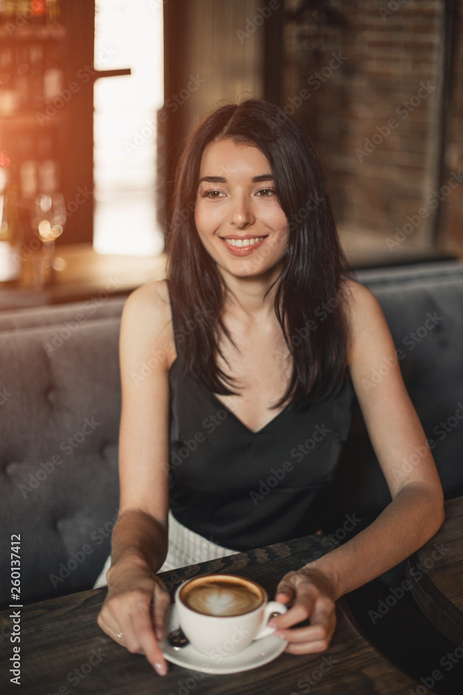 Beautiful woman drinking coffee sitting in a cafe. Beautiful woman drinking coffee sitting in a cafe.