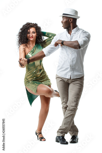 Elegant black man and gorgeous latin girl dancing samba isolated on white background.