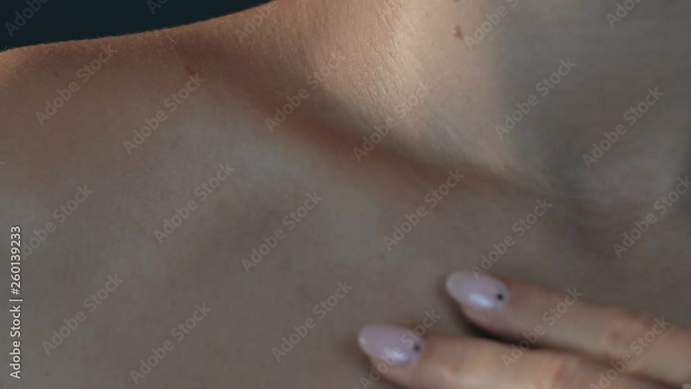 beautiful young woman looking at the camera and smiling. beautiful girl touched to her skin on hand with manicure beautiful young woman looking at the camera and smiling. beautiful girl touched to her skin on hand with manicure
