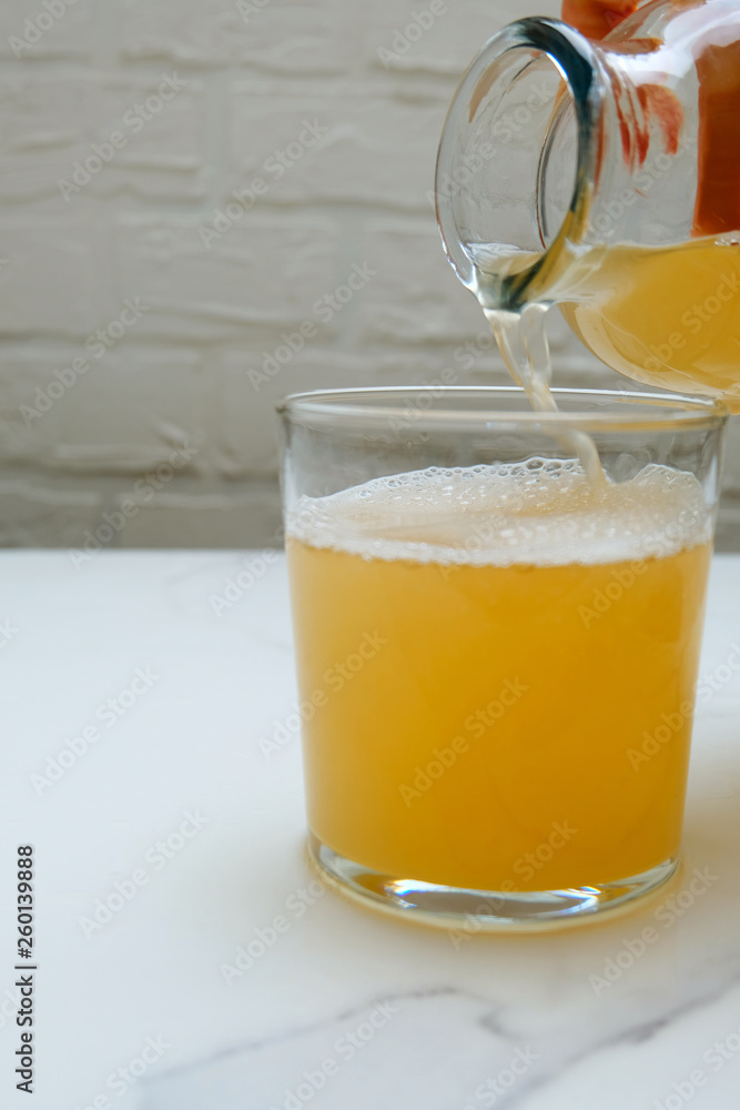 Fermented kombucha tea in a cup. Refreshing detox drink. Fermented kombucha tea in a cup. Refreshing detox drink.