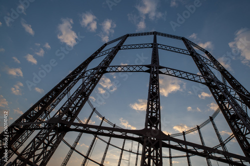 A striking silhouette of an empty gas storage cylinder against the dusk sky in East London.