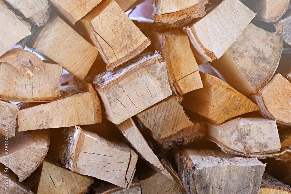 A wall of chopped fire wood stacked neatly on top of each other, background A wall of chopped fire wood stacked neatly on top of each other, background