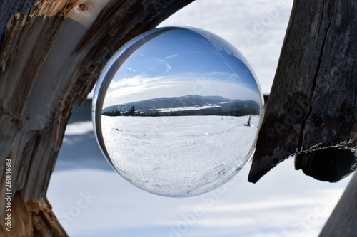 Winter mountains landscape in crystal ball.